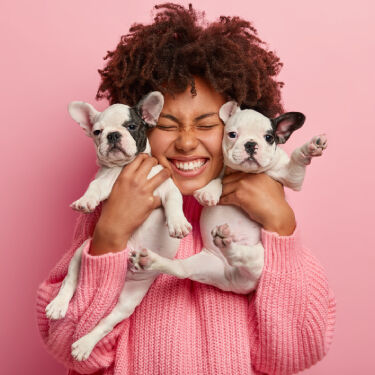 Boy playing with puppy at home.
