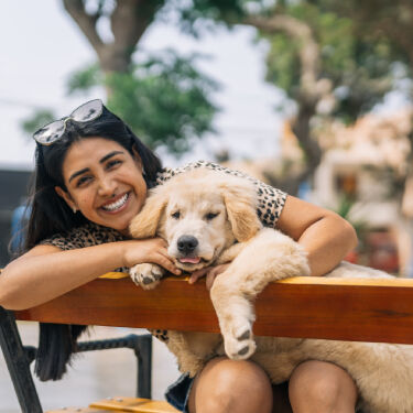 Boy playing with puppy at home.