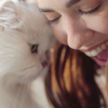 Fancy Feast - smiling girl and cat head to head