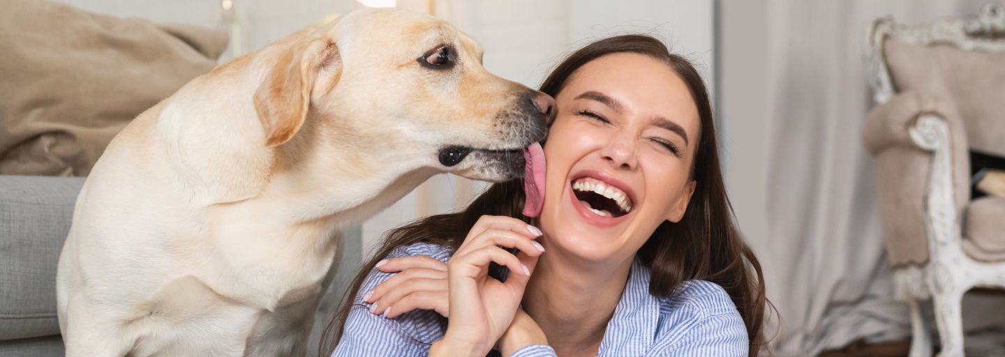 Dog licking woman's face