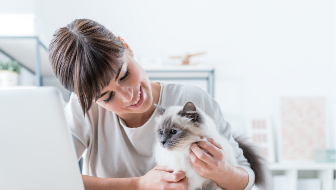 woman patting cat