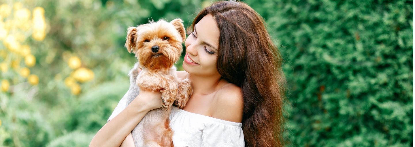 woman giving small dog water