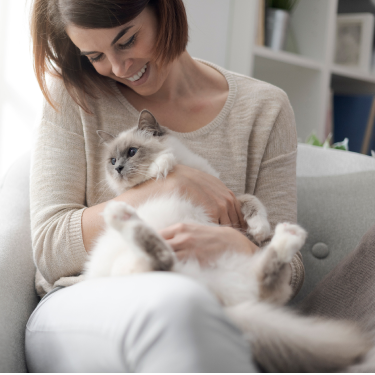 Fancy Feast - woman holding cat and smiling while looking at it