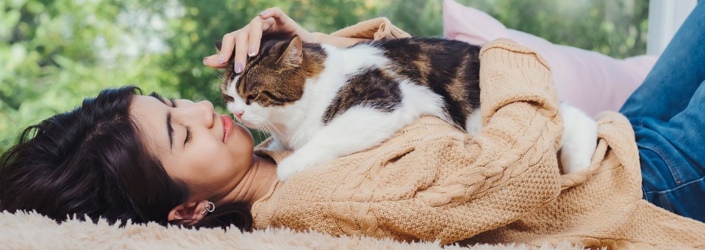 Cay laying on owners chest outside