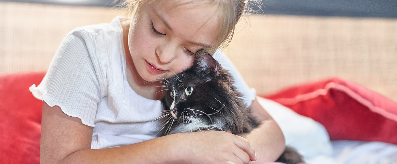 Girl hugging kitten
