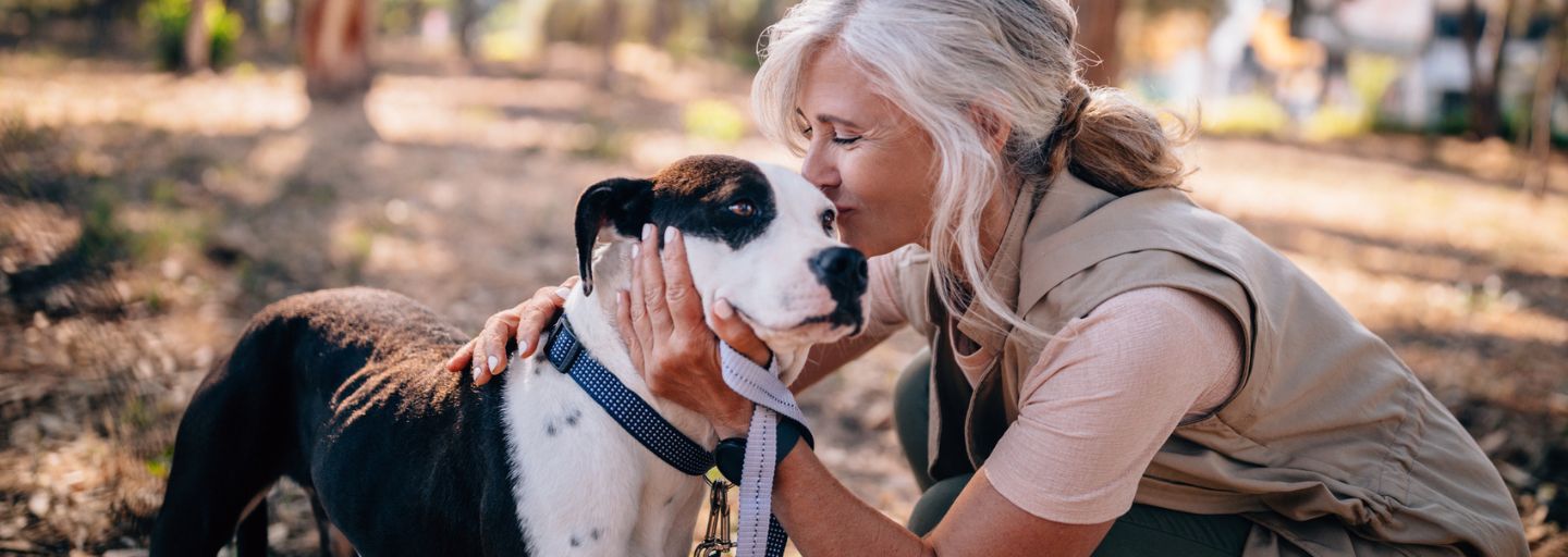 woman kissing dog