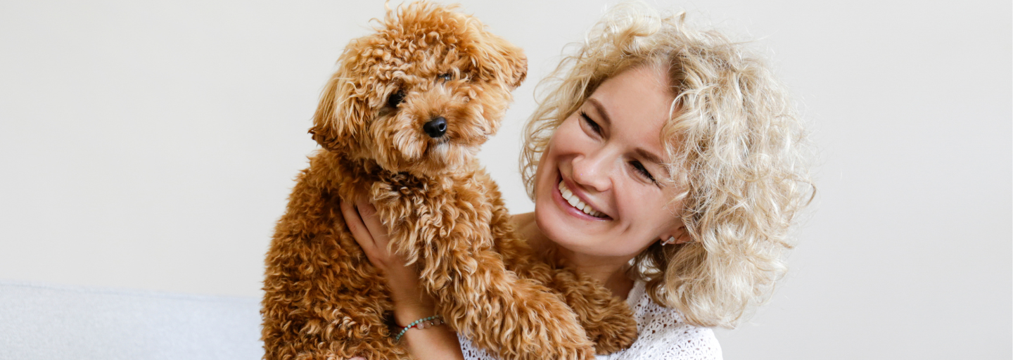 woman holding up a dog