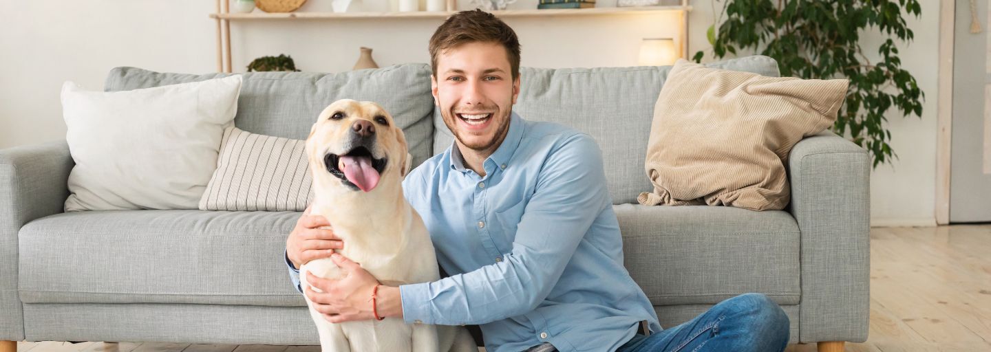 Owner and Dog happily sitting in the lounge room together
